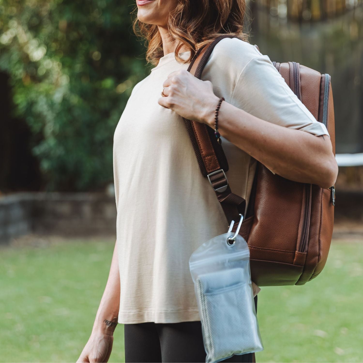 Cooling towel clipped to backpack in waterproof pouch — travel-friendly design for daily use.