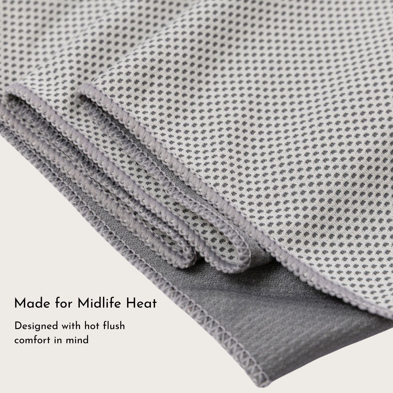 Folded cooling towel displaying micro-mesh design and grey tone.